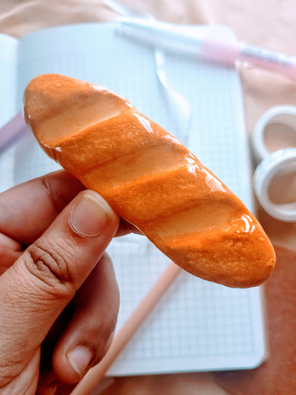 pen rest in the shape of a baguette made with clay