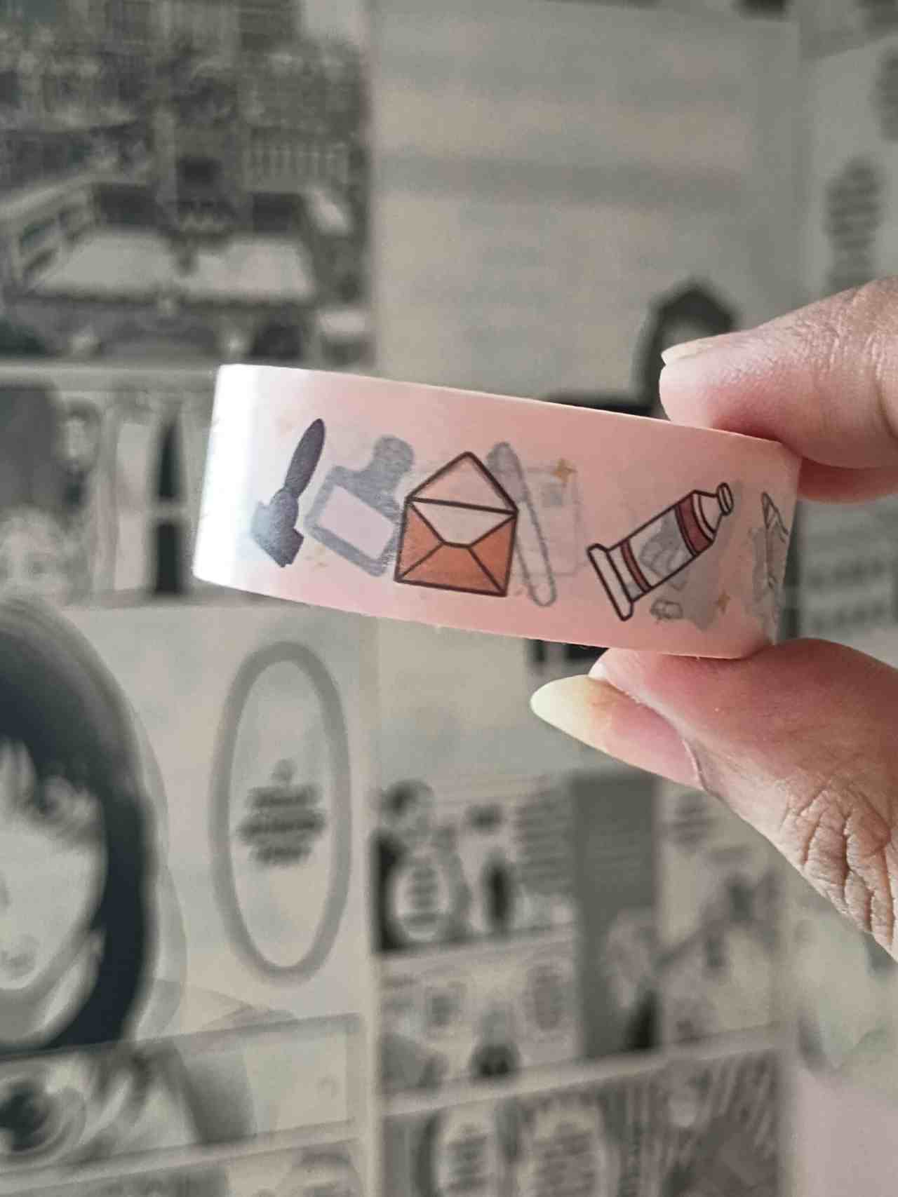 stationary essentials washi tape with cute every day stationary items illustrations held by a hand against a manga background 