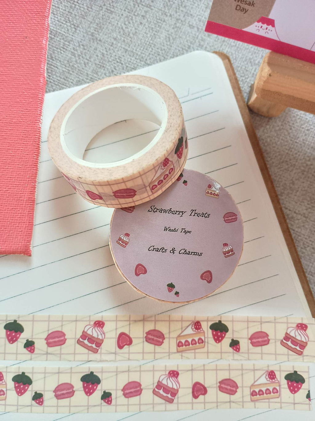 Washi tape labeled 'Strwberry Treats' with cute illustrations of straberry desserts on top  a book