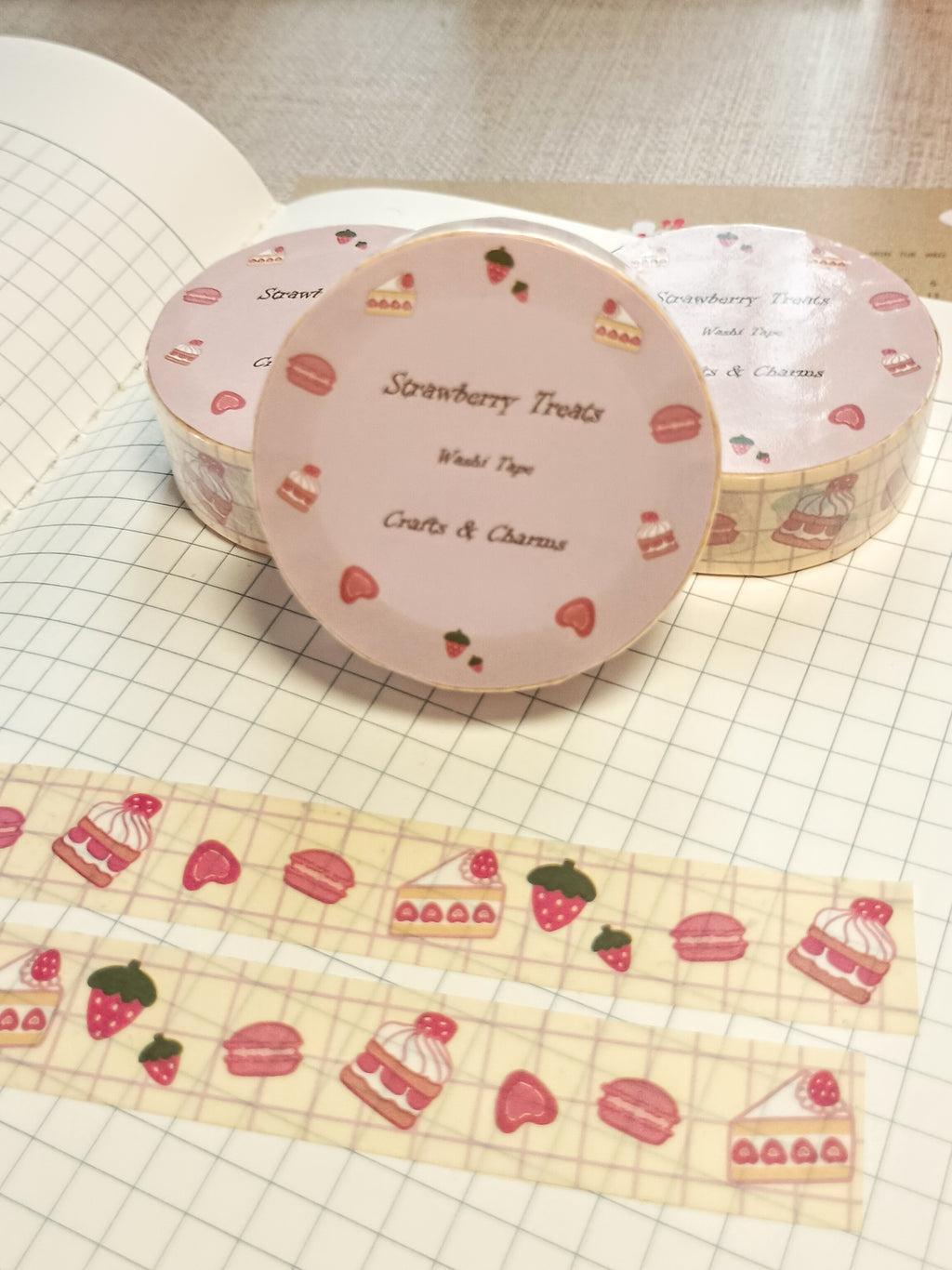 Washi tape labeled 'Strwberry Treats' with cute illustrations of straberry desserts on top a book
